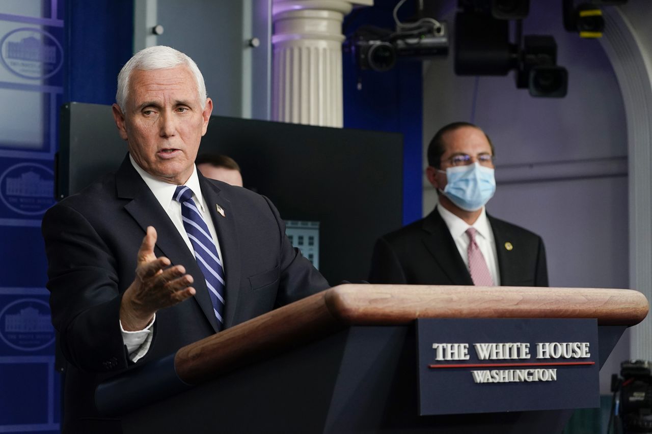 Health and Human Services Secretary Alex Azar, right, listens as Vice President Mike Pence speaks during a news conference with the coronavirus task force at the White House in Washington on Thursday. 