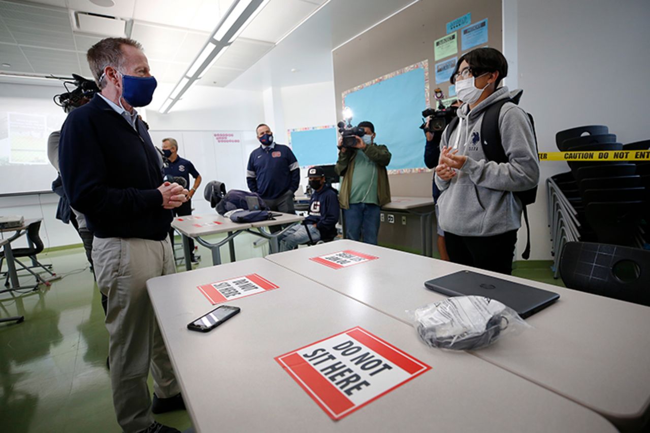 Austin Beutner, left, Superintendent of the Los Angeles Unified School District talks with freshman baseball player David Maldonado, right, in the classroom of physical education teacher and head baseball coach Ruben Torres on the James A. Garfield High School campus as freshmen students arrive for their first time on campus on Tuesday, April 27. 