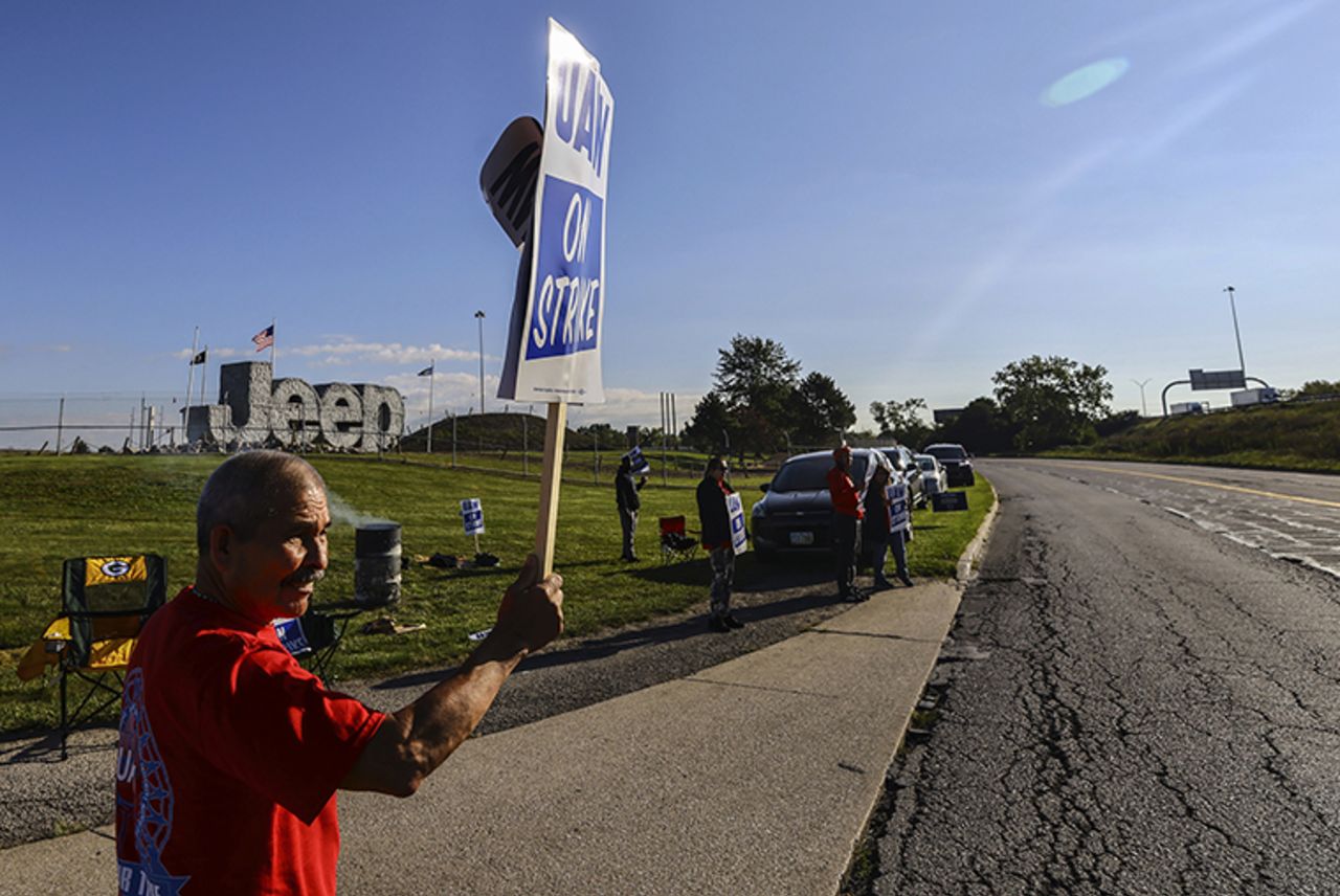 United Auto Workers hold a sign while on strike today at the Stellantis Toledo Assembly Complex in Toledo, Ohio. 