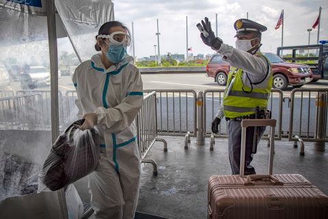 A traveler is seen wearing a protective suit upon arriving at Ninoy Aquino International Airport after a limited number of flights have resumed following relaxed lockdown measures on Friday, May 22, in Manila.
