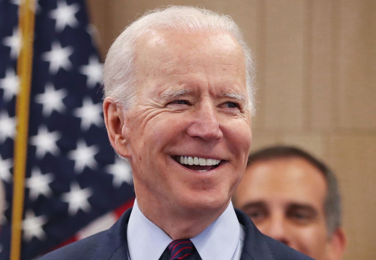 Joe Biden smiles while standing with supporters at a campaign event on March 4, 2020, in Los Angeles.