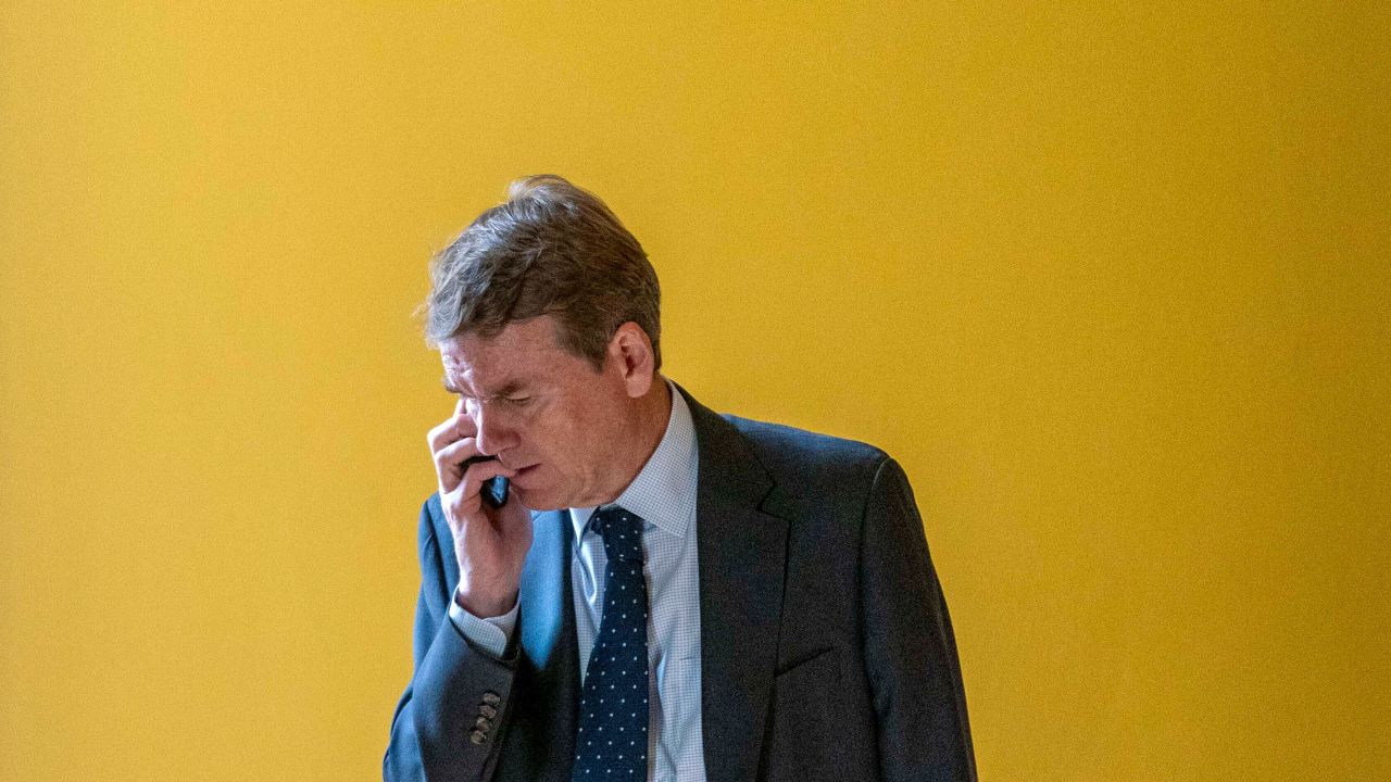 Sen. Michael Bennet speaks on a cellphone in a hallway as the House approved a 45-day funding bill to keep federal agencies open, Saturday, Sept. 30, 2023, in Washington, DC.