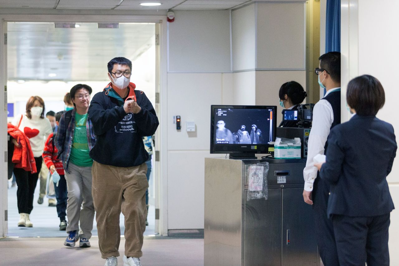 Passengers undergo screened with thermal scanners at Taoyuan International Airport in Taiwan on January 13, 2020.