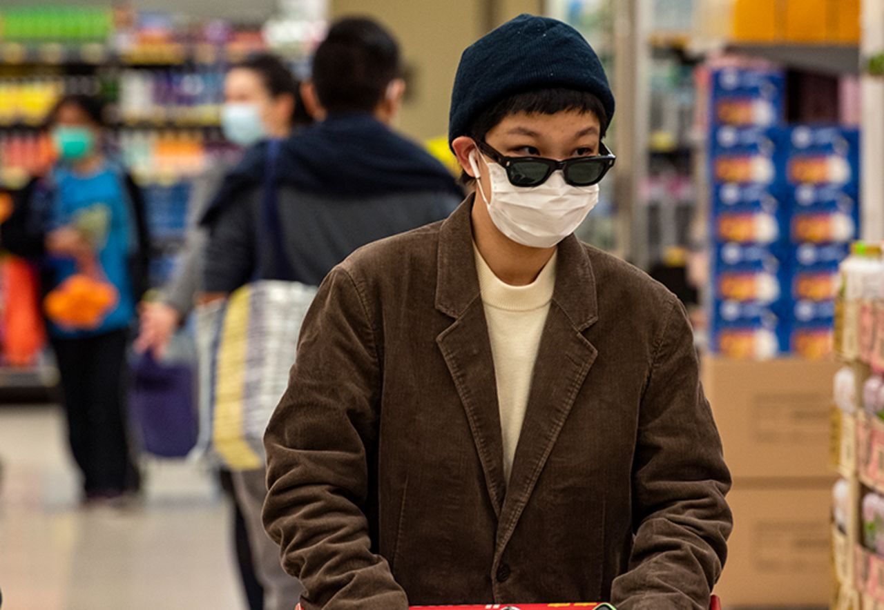 A shopper wearing a face mask and gloves while shopping in a Hong Kong supermarket, Wednesday, February 12.