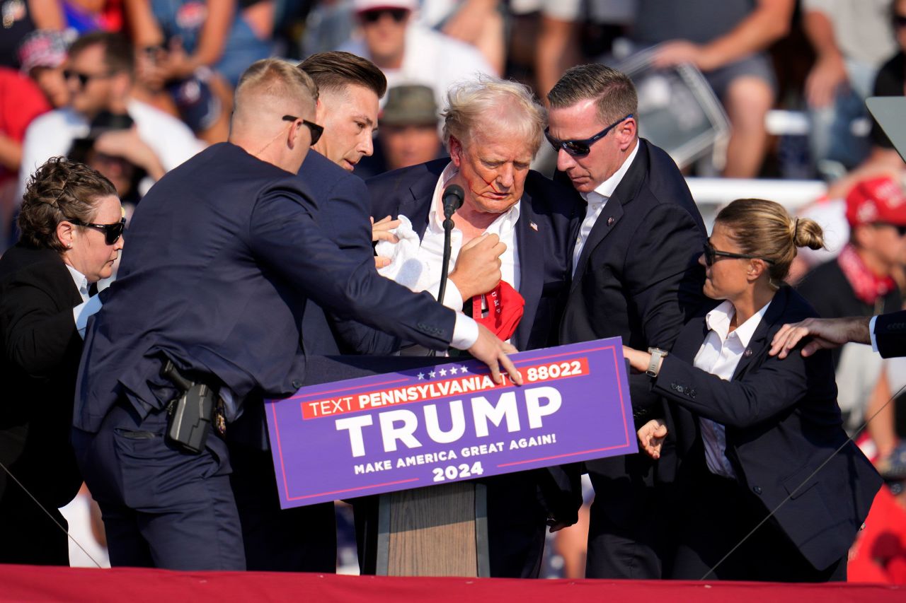 Secret Service agents surround former President Donald Trump after a gunman shot at him during a campaign event in Butler, Pennsylvania, on July 13.