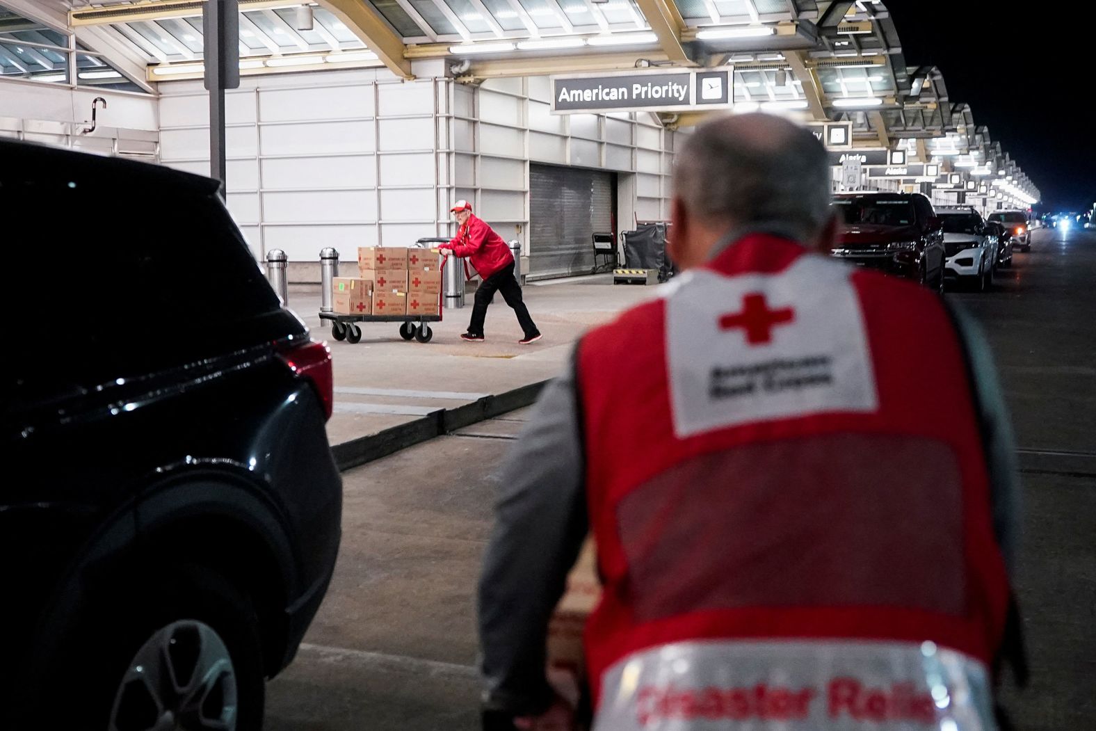 Members of the American Red Cross move disaster relief supplies at a Reagan National Airport terminal on Thursday.