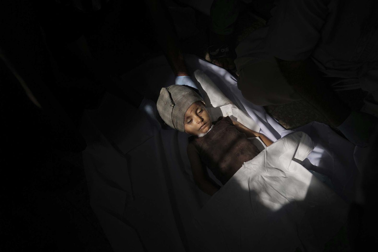 The body of 2-year-old Malek Al-Zaqzouq, who was killed in an Israeli military strike, is prepared for burial at Al-Aqsa Hospital before his funeral in Deir al-Balah, Gaza, on Monday, September 22.
