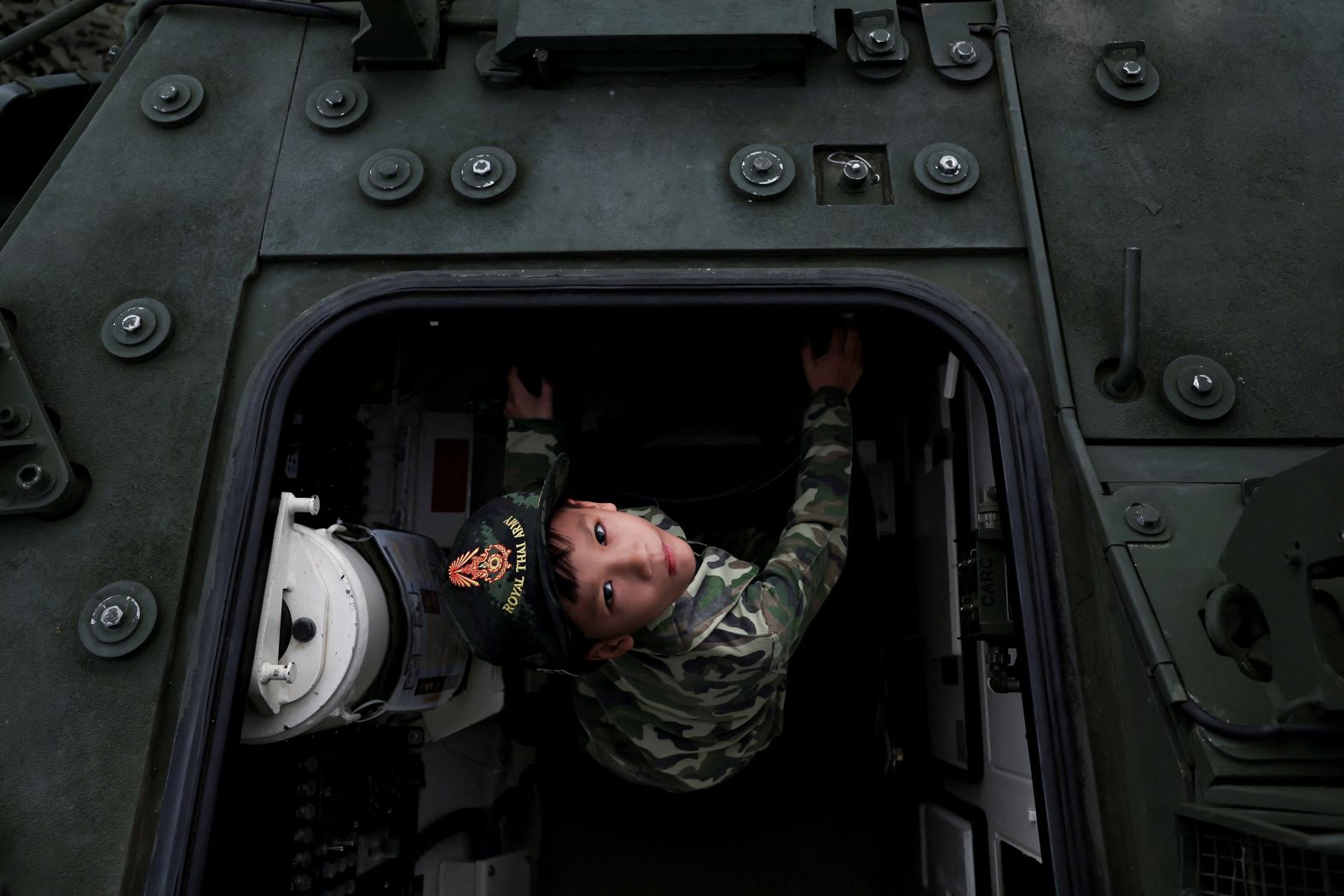 A boy plays in an army vehicle during Children's Day celebrations at a military facility in Bangkok, Thailand, on Saturday, January 11.