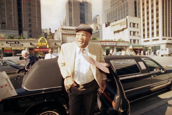 Foreman arrives at a news conference in New York a week after he regained the heavyweight title.