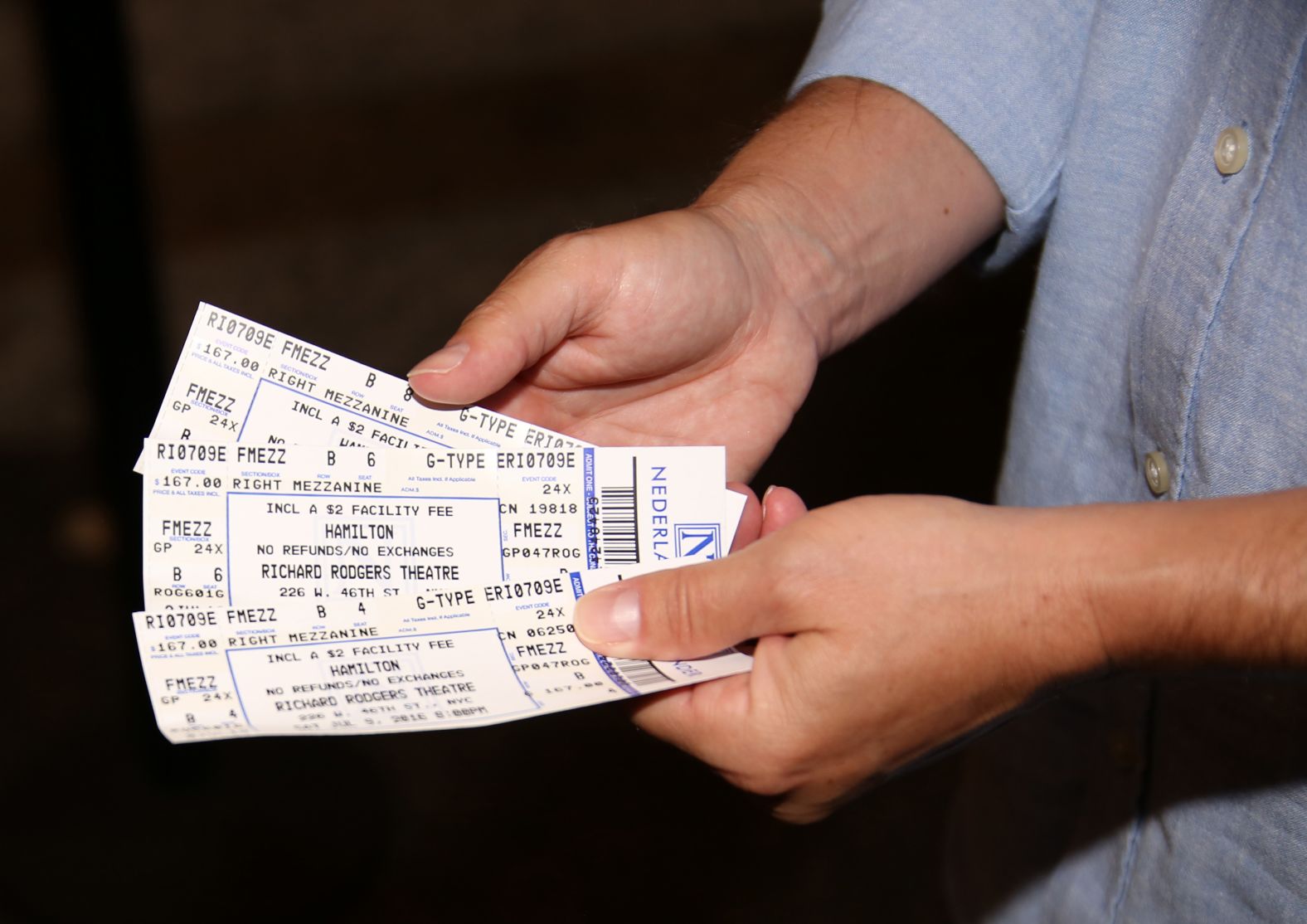 A theatregoer shows their tickets outside Miranda's final performance.