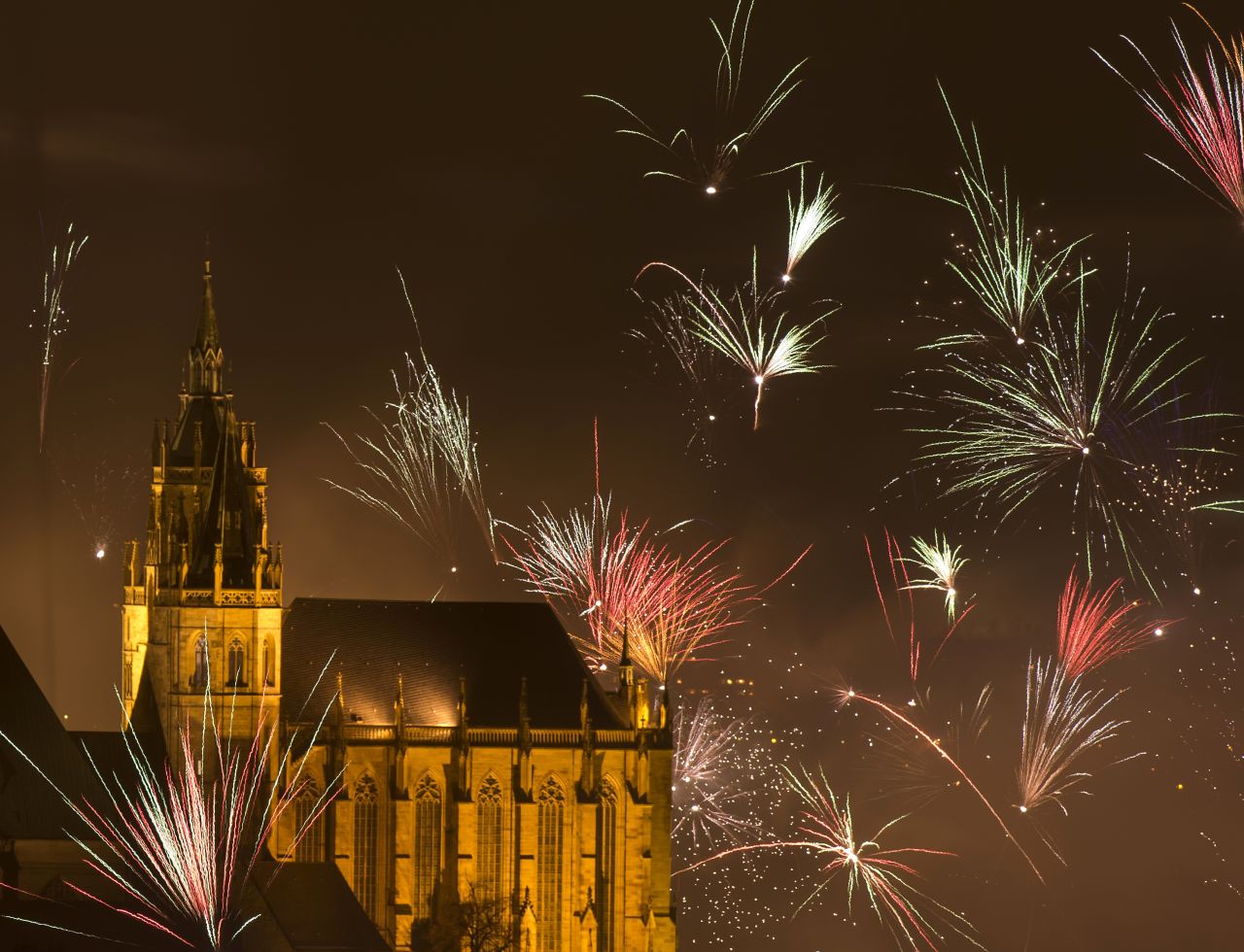 Fireworks explode over St. Mary's Cathedral in Erfurt, central Germany.