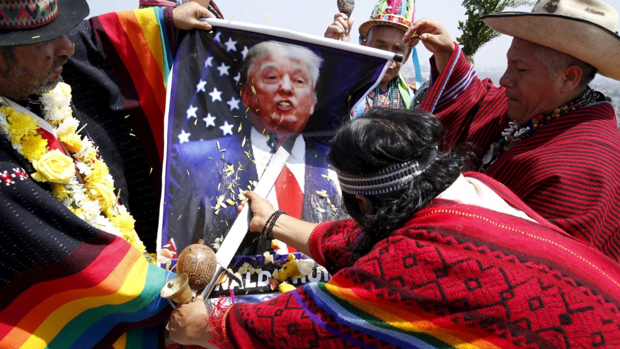 Shamans in Lima, Peru, hold a poster of U.S. presidential candidate Donald Trump as they perform a ritual of predictions on Tuesday, December 29. The ritual is an end-of-year tradition for the shamans, who called for world peace and wished good luck for the upcoming elections in the United States and Peru.