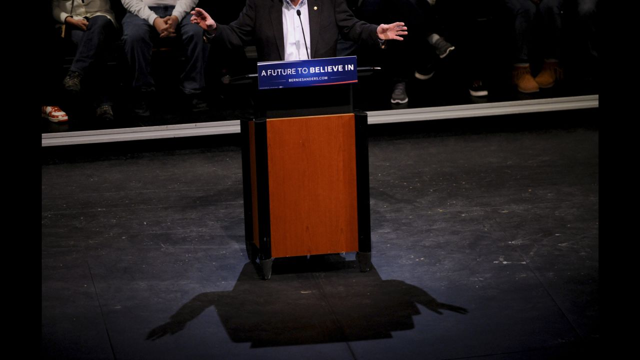 A light casts a shadow of U.S. Sen. Bernie Sanders as the presidential candidate speaks at a town-hall event in Muscatine, Iowa, on Tuesday, December 29.