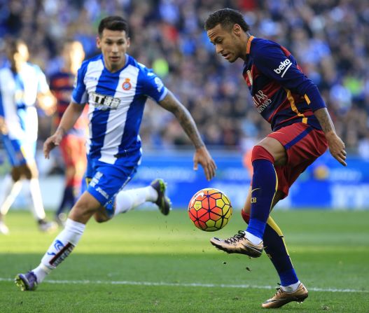 Barcelona's Brazilian forward Neymar (R) controls the ball past RCD Espanyol's Paraguayan midfielder Hernan Perez in what was a closely fought game.
