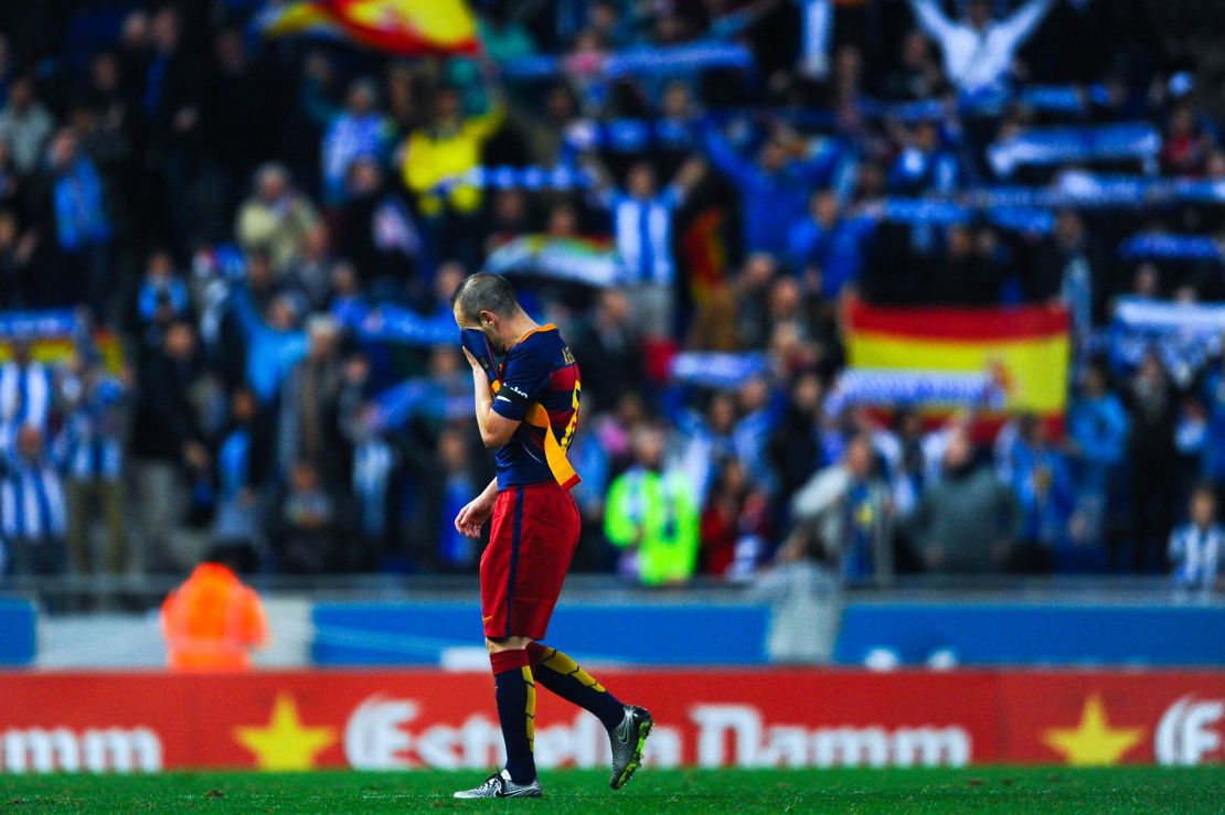 Barcelona playmaker Andres Iniesta leaves the pitch dejected at the end of Saturday's match with Espanyol.