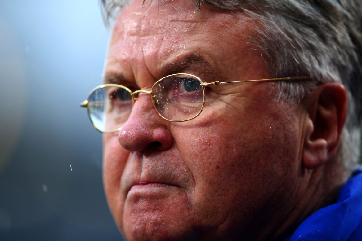 Chelsea interim manager Guus Hiddink watches on in the pouring rain at Selhurst Park.