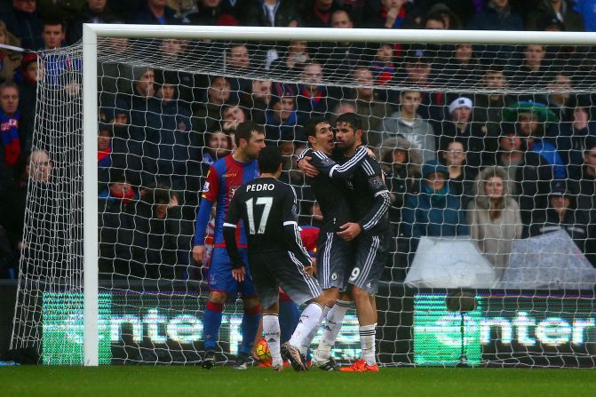 Goalscorer Diego Costa is hugged by teammate Oscar as Chelsea heads for victory in its opening EPL fixture of 2016.