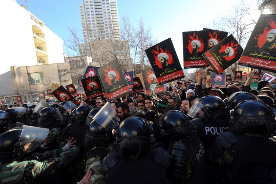 Iranian protesters hold portraits of prominent Shiite Muslim cleric Nimr al-Nimr as they confront riot police during a demonstration against his execution by Saudi authorities on Sunday, January 3, outside the Saudi embassy in Tehran, Iran. Saudi Foreign Minister Adel al-Jubeir told reporters that<a href="http://www.cnn.com/2016/01/03/middleeast/saudi-arabia-executes-dozens-terror/index.html" target="_blank"> Saudi Arabia is severing ties with Iran </a>after an attack on the embassy.