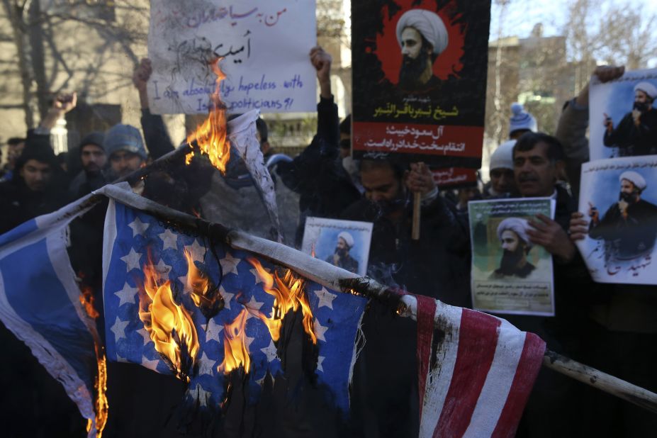 Iranian demonstrators burn representations of the U.S. and Israeli flags during a demonstration in front of the Saudi Arabian Embassy in Tehran on January 3. 