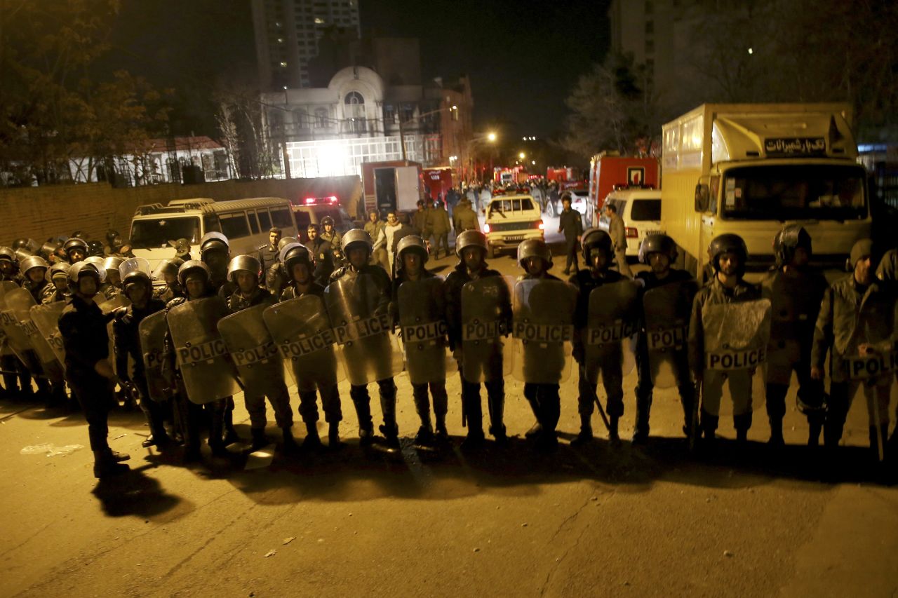 Iranian security guards Saudi Arabia's embassy in Tehran while a group of demonstrators gathered to protest on January 3.