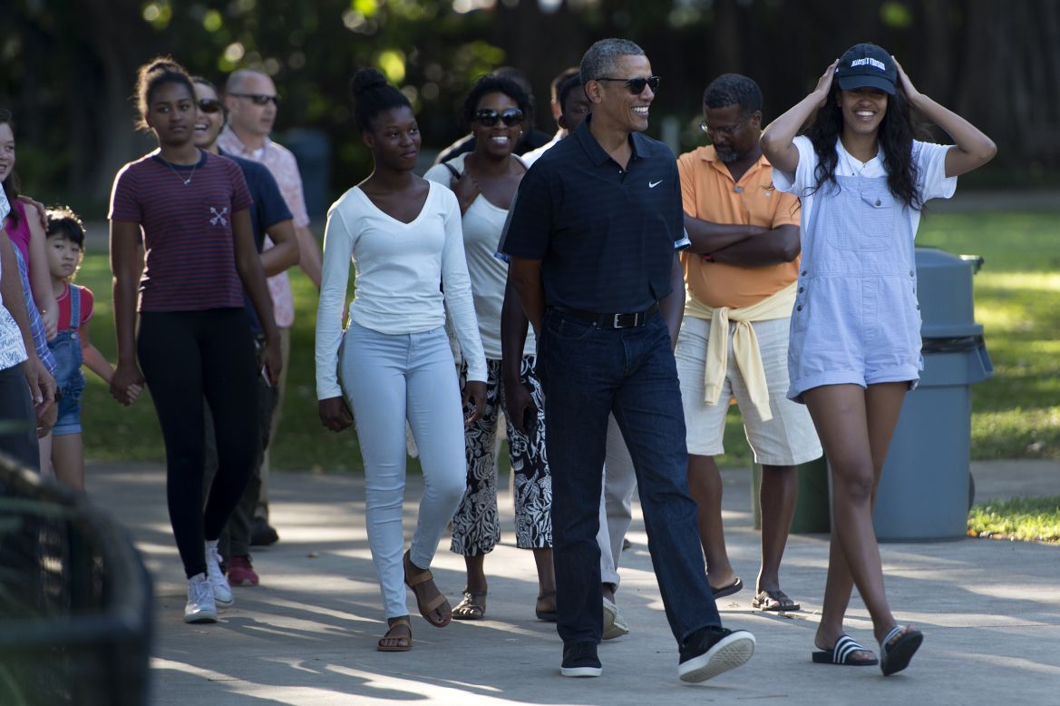 The President walks with his daughters and other members of his family during a visit to the Honolulu Zoo on Saturday, January 2.