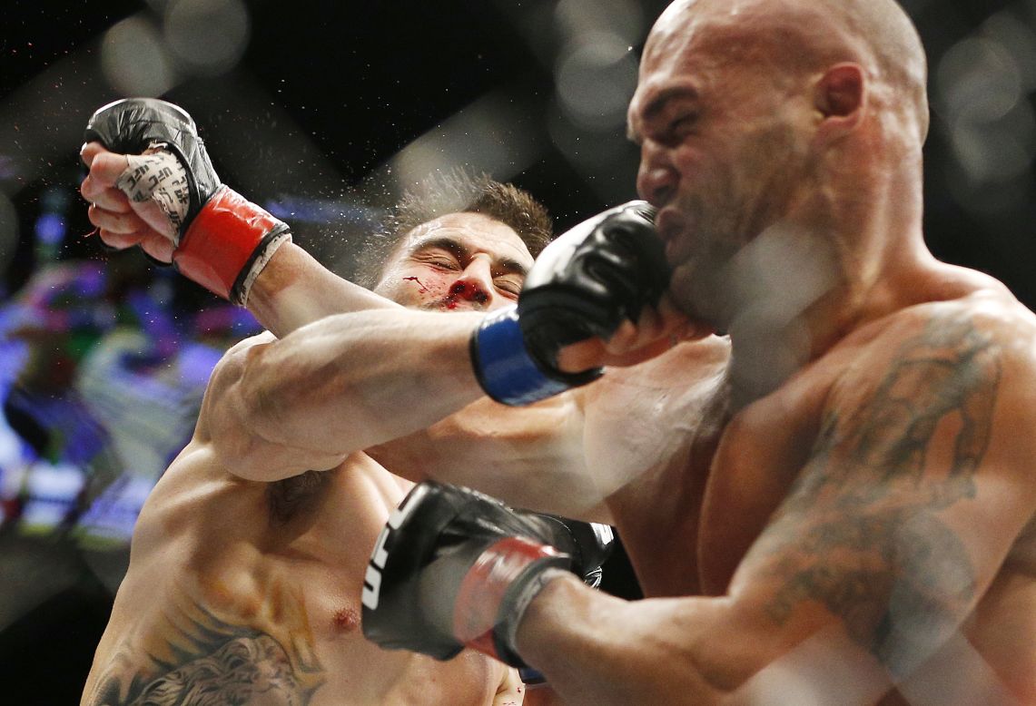 UFC fighter Carlos Condit, left, trades blows with Robbie Lawler during their welterweight title fight in Las Vegas on Saturday, January 2. Lawler retained his title by split decision.