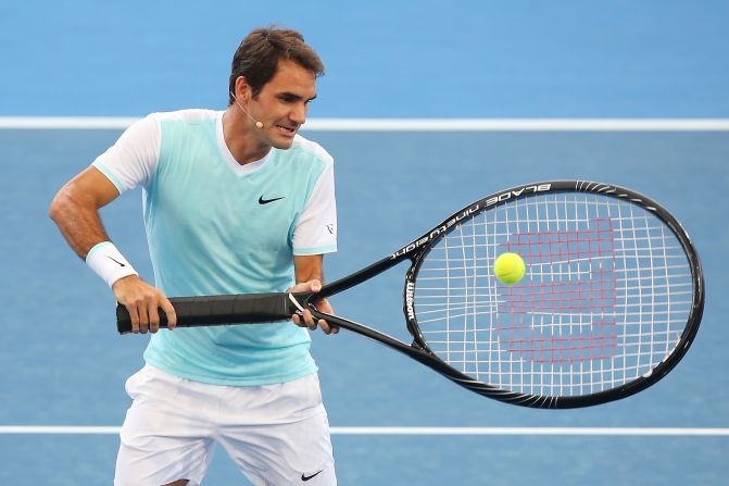 Roger Federer has some fun with an oversized racket during an exhibition event in Brisbane, Australia, on Sunday, January 3.