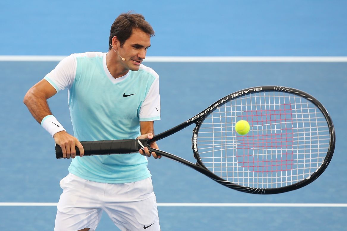 Roger Federer has some fun with an oversized racket during an exhibition event in Brisbane, Australia, on Sunday, January 3.