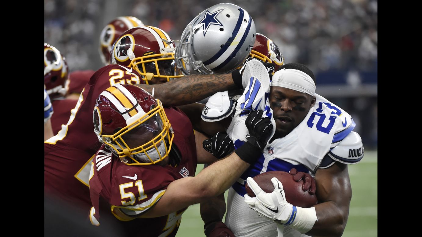 Dallas' Robert Turbin loses his helmet as he's crunched by Washington Redskins on Sunday, January 3. A personal foul was called on the play.