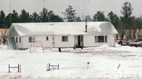 An unidentified man appears to point a rifle from the open door of Justus Township headquarters for the freemen group, some 30 miles outside Jordan, Montana, on March 27, 1996.