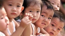 BEIJING, CHINA:  A group of Chinese children gather at a park in Beijing 29 July 1999. Two decades of China's state-imposed "one-child policy" has given way to more than 53 million "little emperors," doted on by parents and grandparents eager to provide for their sole offspring.   (ELECTRONIC IMAGE)   AFP PHOTO/Stephen SHAVER (Photo credit should read STEPHEN SHAVER/AFP/Getty Images)