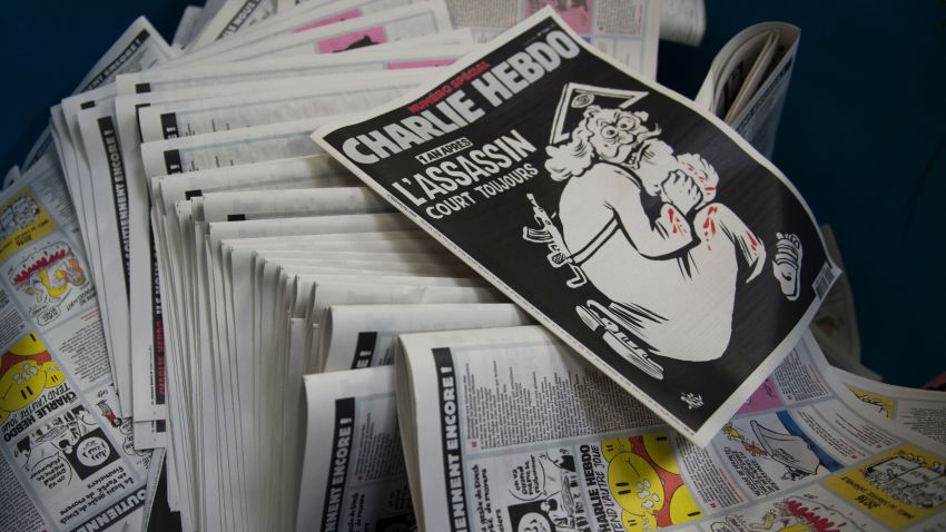 A picture taken on January 4, 2016 at a printing house near Paris shows the cover of the latest edition of the French Satirical magazine Charlie Hebdo bearing a headline which translates as "One year on: The assassin still at large" in an edition to mark the first anniversary of the terror attack which targetted the magazines offices in Paris on January 7, 2015.
One million copies of the special edition will go on sale in France on January 6, on the eve of the first anniversary of the killing of 12 people at the magazine's Paris offices by brothers Cherif and Said Kouachi.  / AFP / MARTIN BUREAU        (Photo credit should read MARTIN BUREAU/AFP/Getty Images)