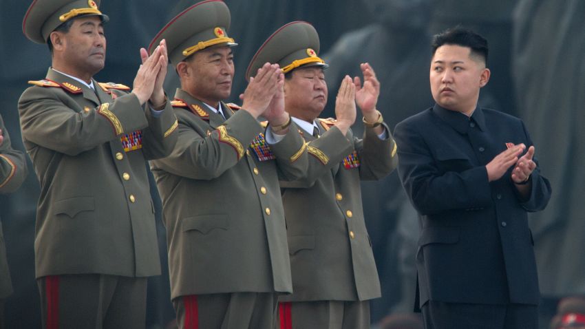 North Korean leader Kim Jong-Un (R) claps as he attends the unveiling ceremony of two statues of former leaders Kim Il-Sung and Kim Jong-Il in Pyongyang on April 13, 2012.  North Korea's new leader Kim Jong-Un on April 13 led a mass rally for his late father and grandfather following the country's failed rocket launch. AFP PHOTO / Ed Jones        (Photo credit should read Ed Jones/AFP/Getty Images)