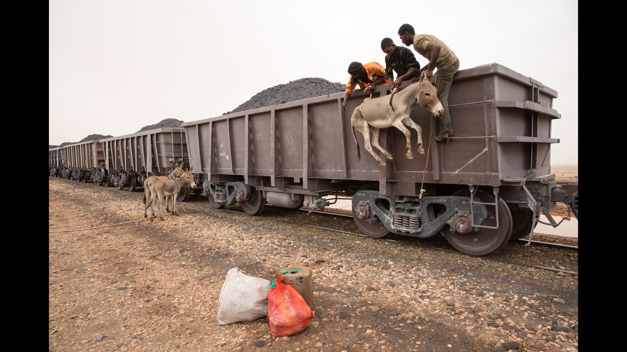 A donkey is loaded onto a train filled with iron ore in the West African country of Mauritania. Photographer George Popescu rode the train last fall -- a 40-hour round-trip journey through the Sahara desert.