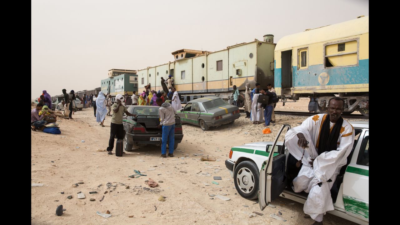 People exit the train after arriving at the Nouadhibou harbor.
