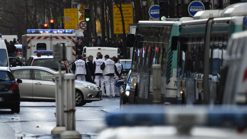 Rescue workers are seen at the Boulevard de Barbes in the north of Paris on January 7, 2016, after police shot a man dead as he was trying to enter a police station in the Rue de la Goutte d'Or. The man shot dead by police on the first anniversary of the jihadist assault on Charlie Hebdo had a knife and what appeared to be an explosives vest, the government said. The man was also heard to shout "Allahu Akbar" as he approached the police station in the multi-ethnic neighbourhood in the north of the capital, the interior ministry said. AFP PHOTO / LIONEL BONAVENTURE / AFP / LIONEL BONAVENTURE        (Photo credit should read LIONEL BONAVENTURE/AFP/Getty Images)