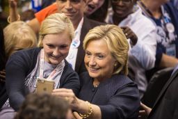 Democratic presidential candidate Hillary Clinton takes a selfie with a supporter during the New Hampshire Democratic Party Convention at the Verizon Wireless Center on September 19, 2015 in Manchester, New Hampshire.