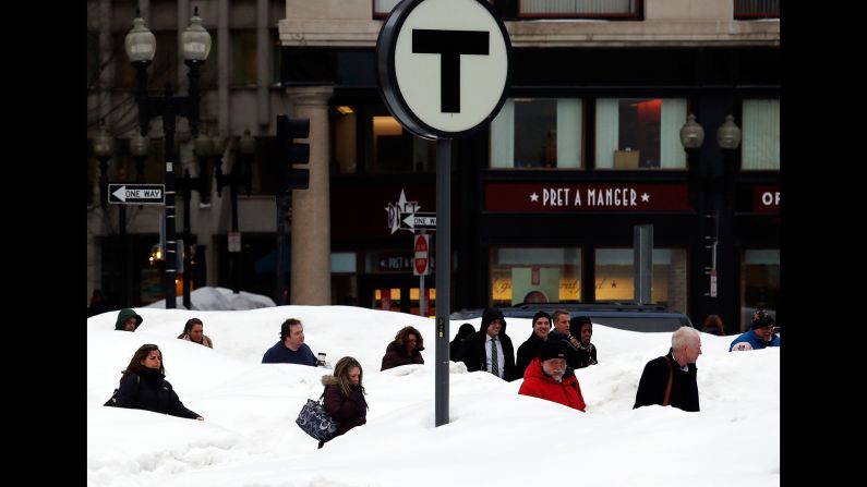 Pedestrians are obscured by huge snowbanks in downtown Boston, Massachusetts, on February 19. The huge drifts were the result of the latest in a series of major snowstorms that impacted the region during January and February.  Nearly 65 inches of snow fell in Boston during the record-setting month of February, adding to the rest of the season's snowfall -- 45 inches -- to be the snowiest winter in Boston's history.  