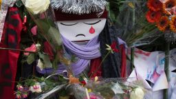 TOPSHOT - A doll crying is seen among flowers at a makeshift memorial in tribute to the victims of the Paris terror attacks, on January 4, 2016, outside the Bataclan concert hall in Paris, ahead of the one year anniversary of the jihadist attack on French satirical weekly newspaper Charlie Hebdo.
Eight Charlie Hebdo staff were among the victims of the January 7, 2015 assault which brought millions of people onto France's streets in protest and transformed a fading publication into a global symbol of freedom of expression. / AFP / JOEL SAGET        (Photo credit should read JOEL SAGET/AFP/Getty Images)
