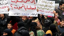 IDLIB, SYRIA - JANUARY 5: Demonstrators hold banners during a protest for civilians who starved to death in Madaya, on January 5, 2016 at Maret el Numan district of Idlib, Syria. (Photo by Firas Faham/Anadolu Agency/Getty Images)