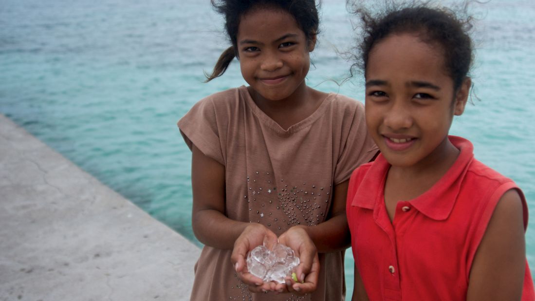 With no refrigeration on Kapingamarangi Atoll, children are fascinated by ice cubes brought ashore by the crew of expedition cruise ship Silver Discoverer. 