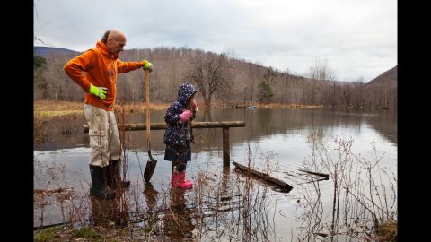True and her father assess damage to a sinking bridge in 2011. She assists her father with outdoor tasks and is being taught various subjects with an emphasis on religion and music.