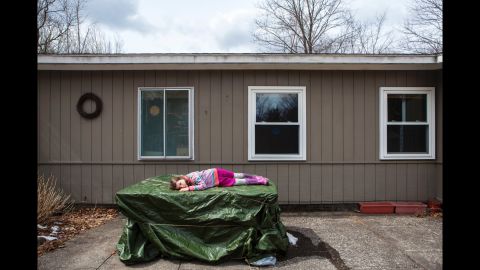 Rosabel lies outside her house in 2013.