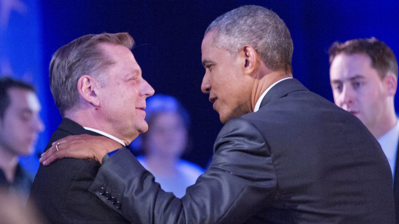 Obama stops to greet the Rev. Michael Pfleger, a noted gun control activist from Chicago, during a commercial break.