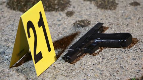 A gun sits by a marker after Thursday night's shooting in west Philadelphia.