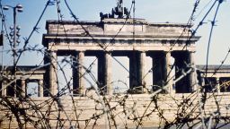 It's 1968, and Berlin's Brandenburg Gate is seen through a swirl of barbed wire.