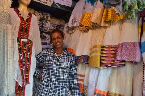 A trader in Shiro Meda, Addis's large market for traditional clothes and souvenirs, poses with her wares. Always go ready to haggle hard.