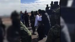 "EL CHAPO" ESCORTED BY POLICE INTO JET