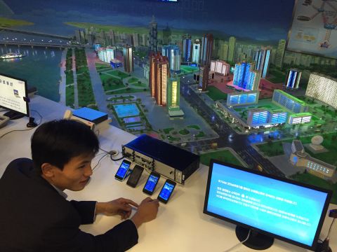 A guide shows visitors a display in the North Korean Science and Technology Center.