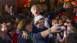 Screenwriter and actress Lena Dunham is photobombed by former U.S. Women's National Soccer Team captain Abby Wambach while taking a selfie after talking to a crowd at a Hillary Clinton for President event on January 8, 2016 in Manchester, New Hampshire.